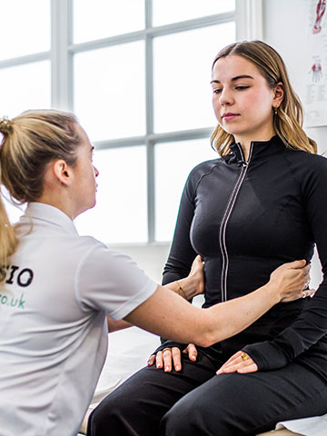A Women’s Health Physiotherapist assessing a female client